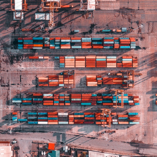 birds eye view of shipping containers stacked at a port.